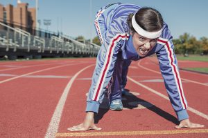 Runner on racetrack, signifying why you should focus on your goals for dealership emails