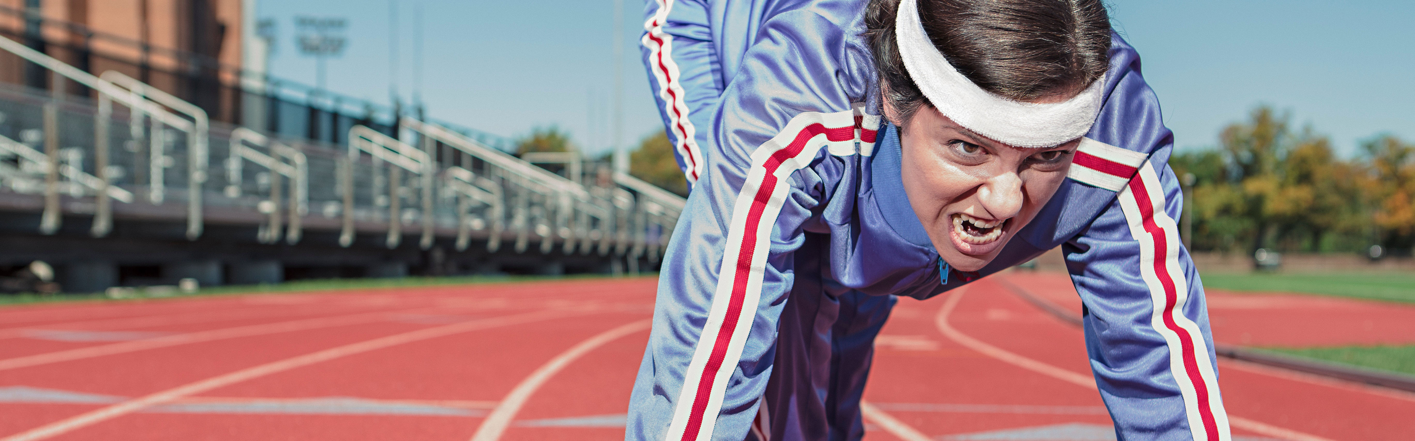 Intense runner on a track, illustrating setting a goal for split testing on Facebook