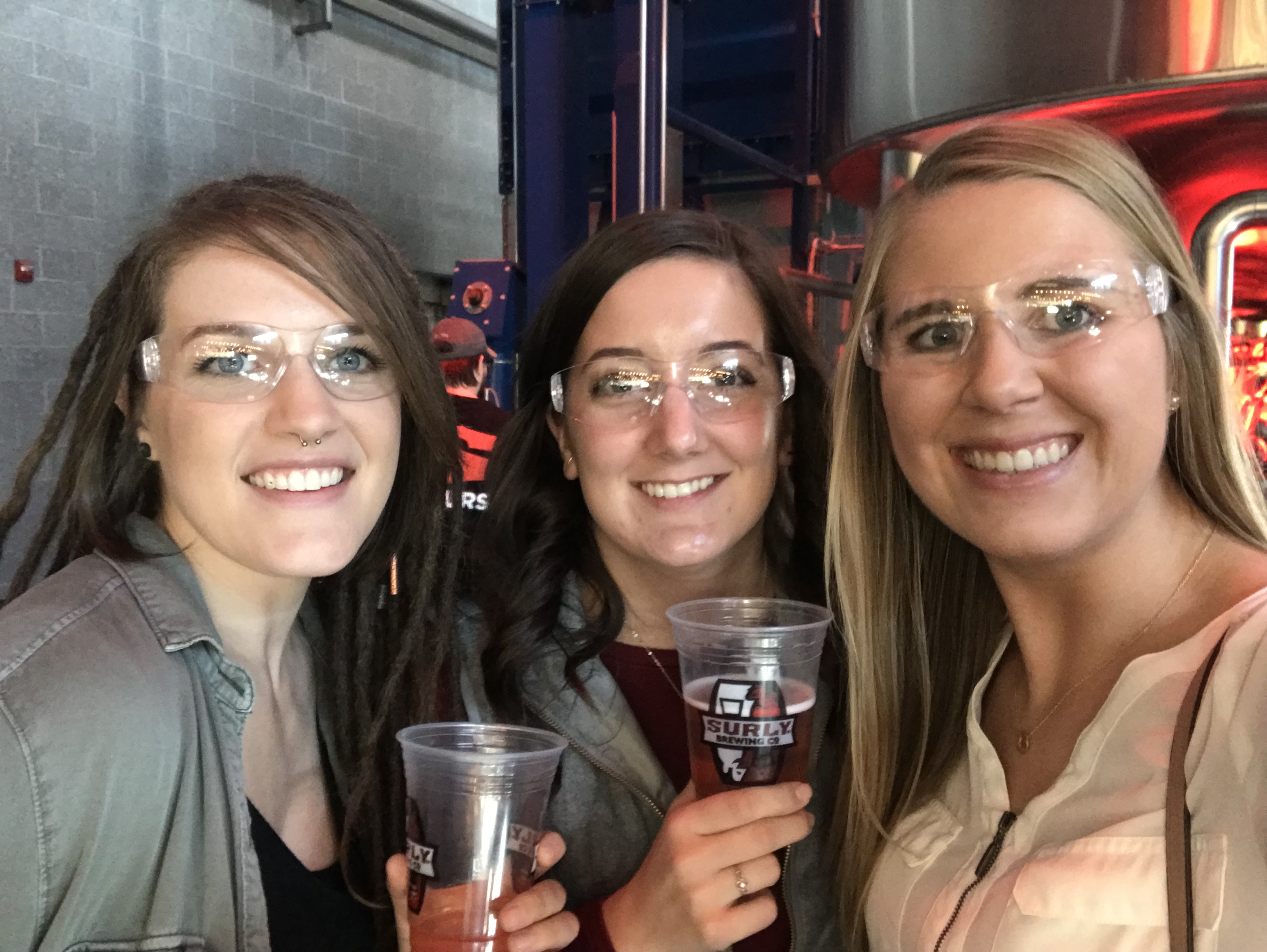 Jaden, Catherine, and Jacquelyn from 9 Clouds show off their cool eyewear on the Surly brewery tour.