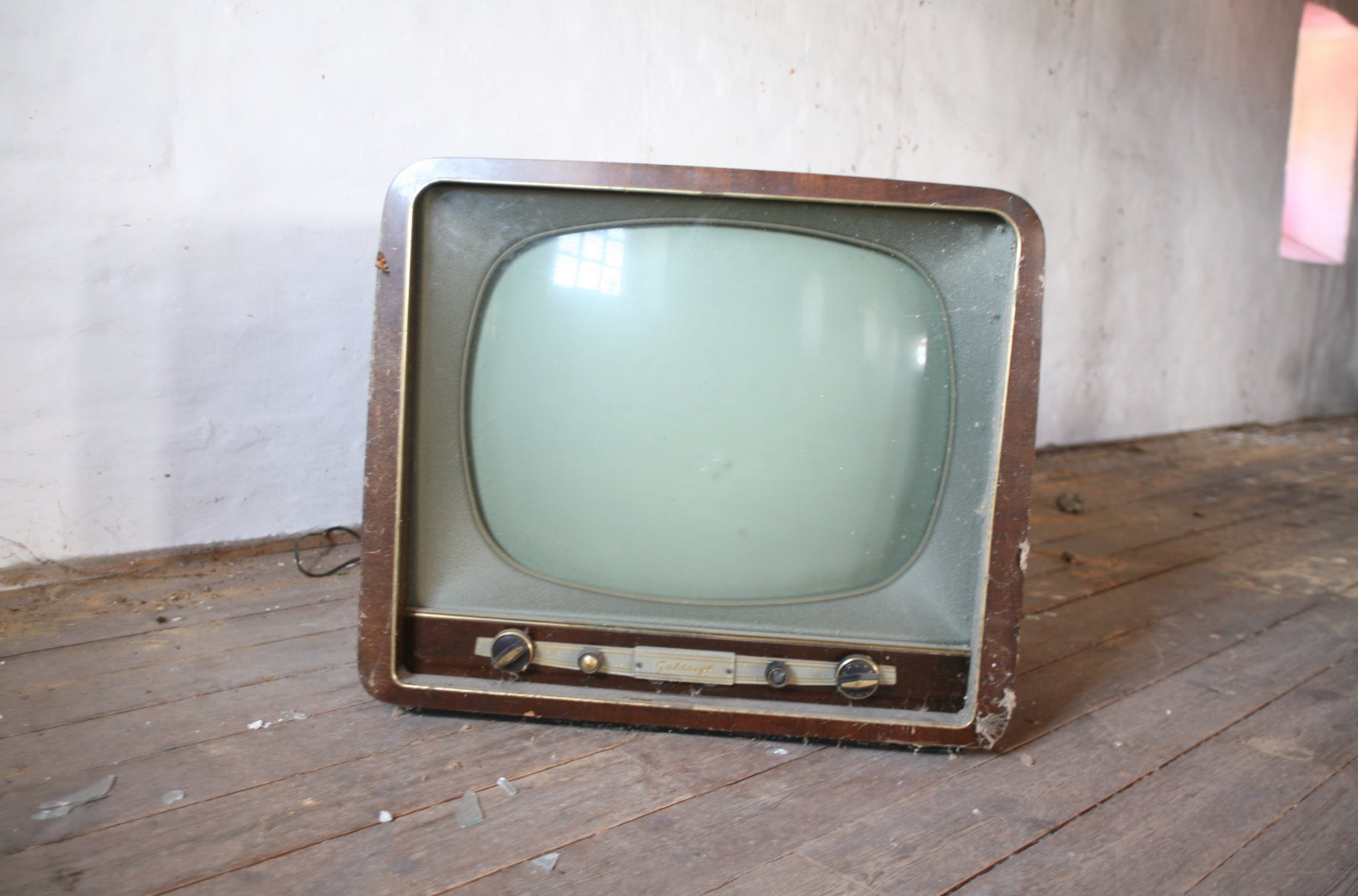 An old TV on a wood floor, indicating dated traditional marketing methods.