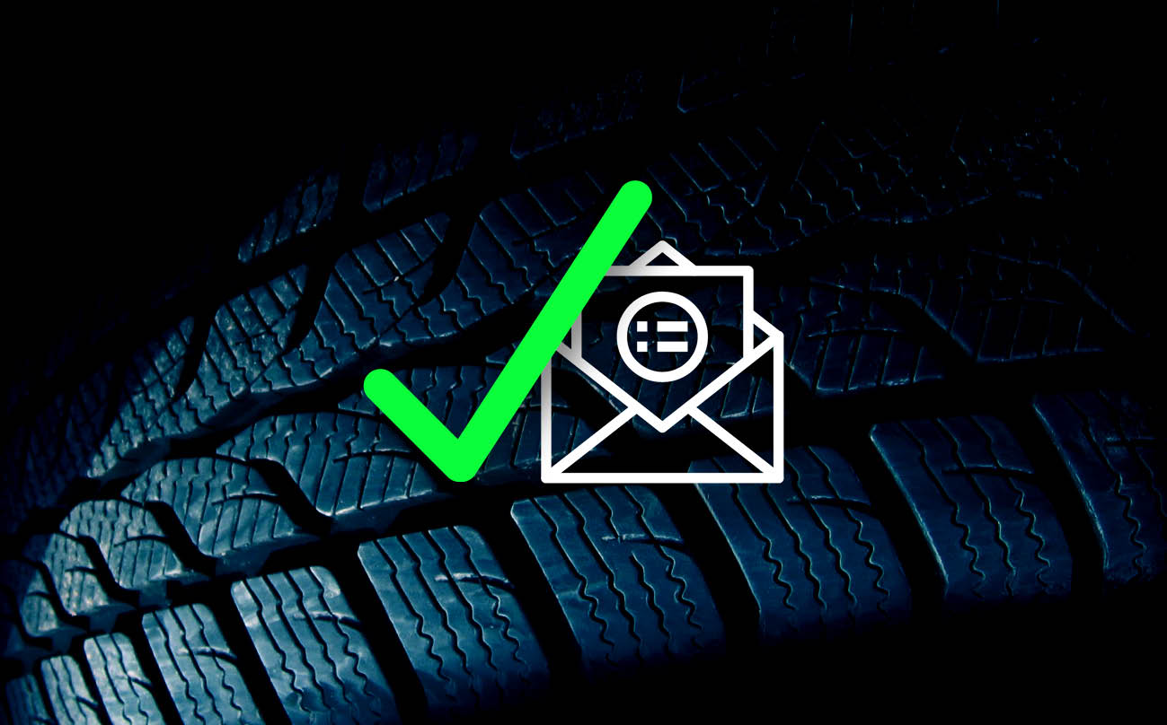 A green check mark and white email graphic over a black tire tread background